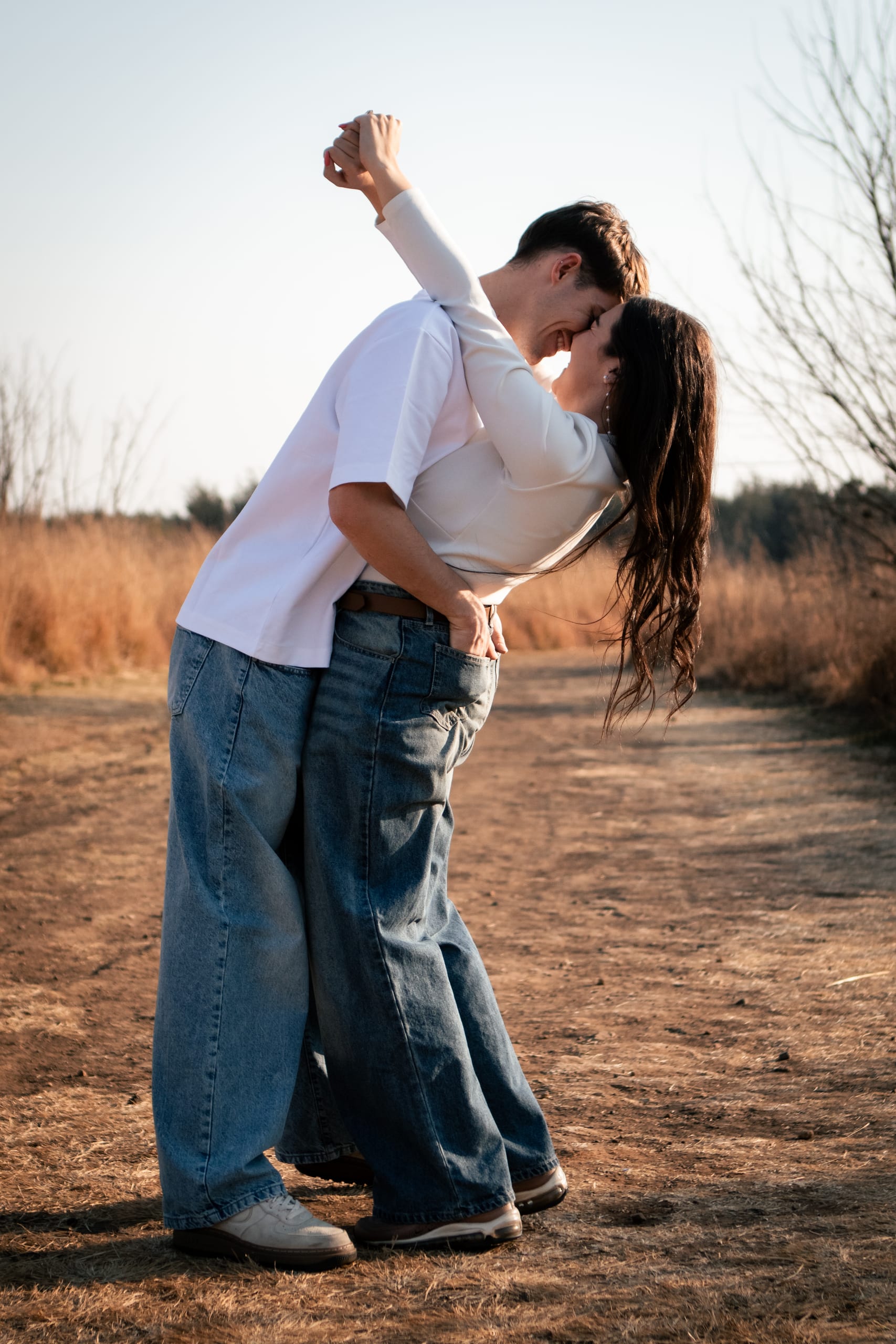 Gareth dipping Shannon playfully on a path during their engagement session