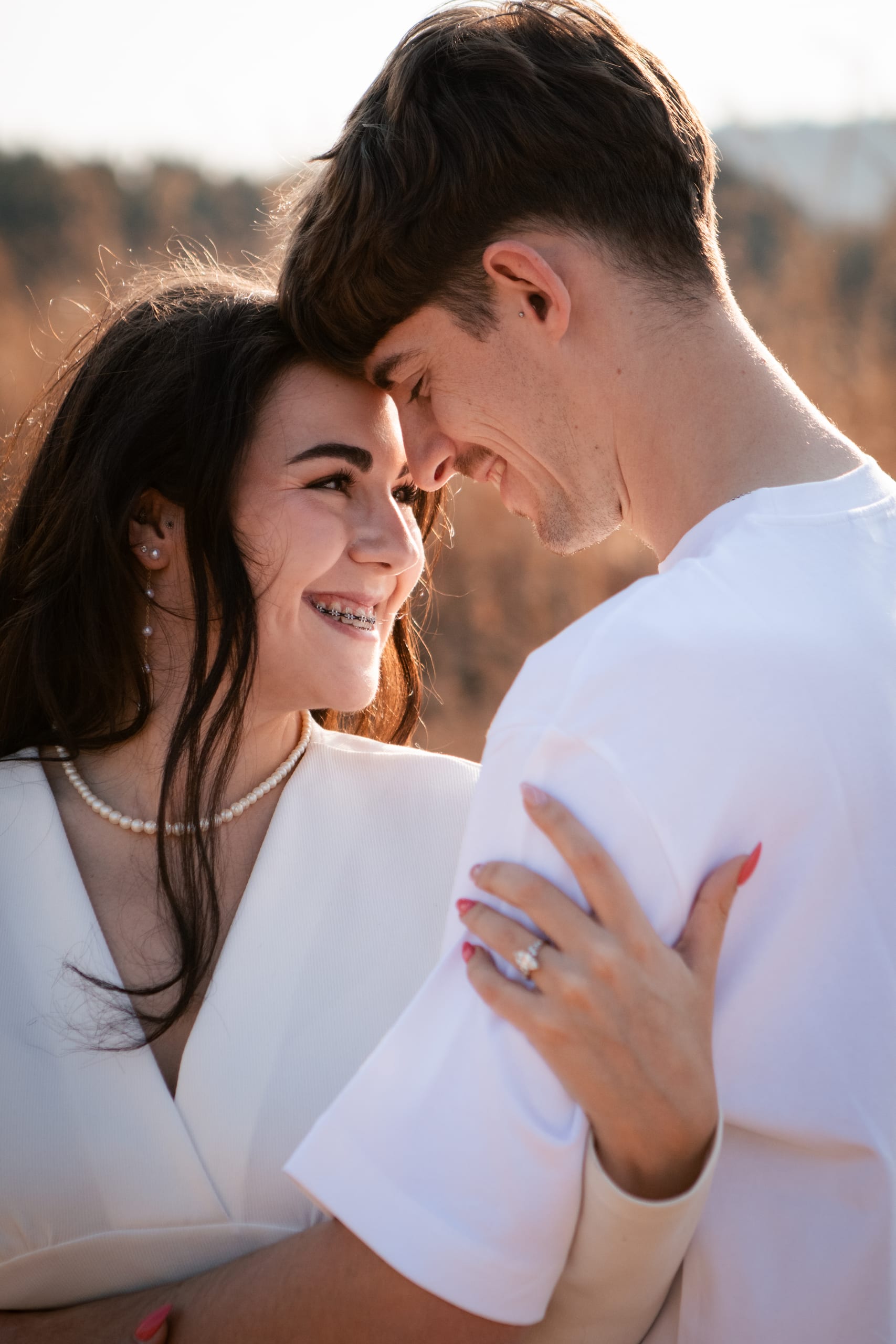 Gareth and Shannon smiling forehead to forehead during their engagement session